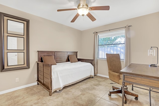 bedroom with ceiling fan, baseboards, and light tile patterned floors