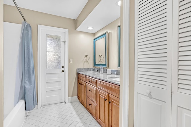 bathroom with double vanity, shower / bath combo, a closet, tile patterned flooring, and a sink