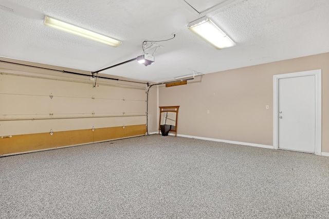 garage with baseboards and a garage door opener