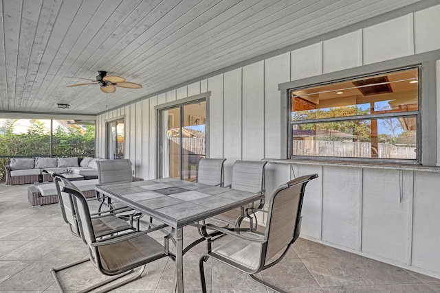 sunroom with wood ceiling and a ceiling fan