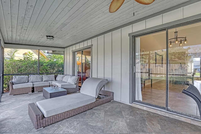 sunroom / solarium featuring a ceiling fan and wooden ceiling