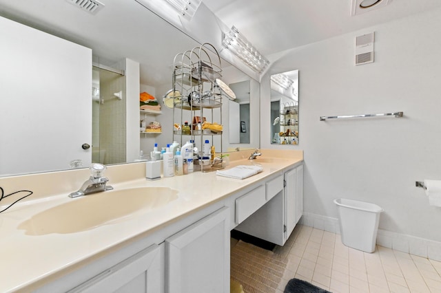 6065 Pointe Regal Cir Unit 307, Delray Beach, FL 33484 - bathroom featuring double vanity, tile patterned flooring, a stall shower, and baseboards