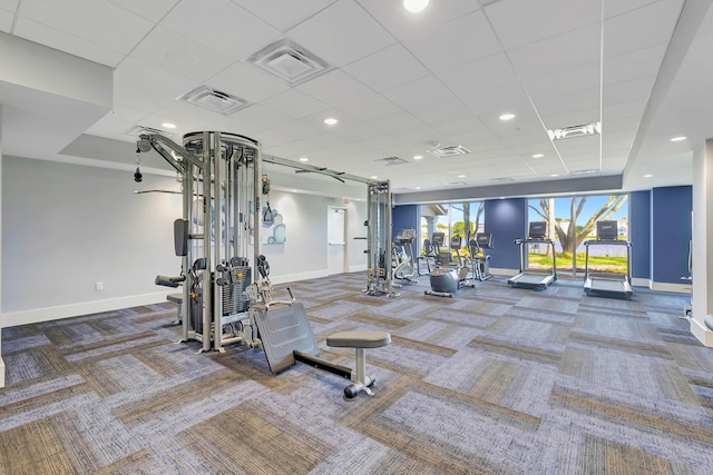 gym featuring carpet and a paneled ceiling