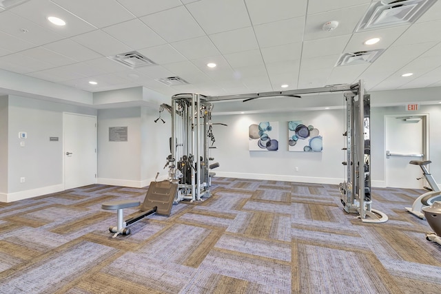 exercise room featuring carpet flooring and a drop ceiling