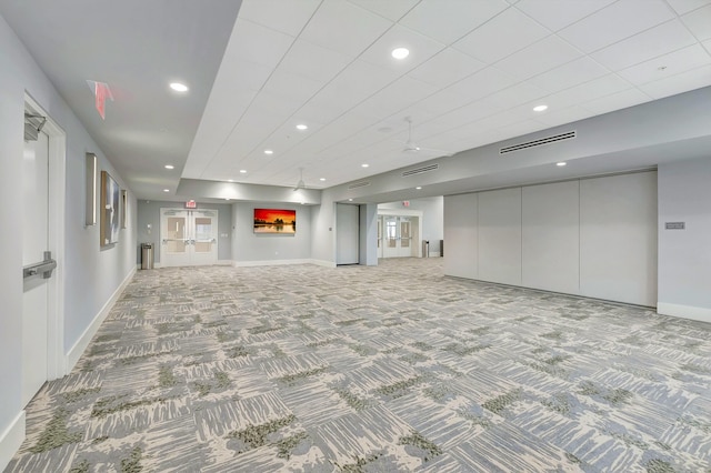 unfurnished living room with light colored carpet and french doors