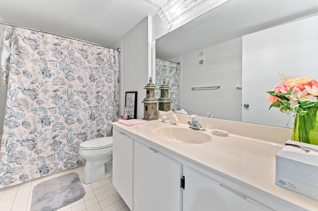 bathroom featuring vanity, toilet, and tile patterned flooring