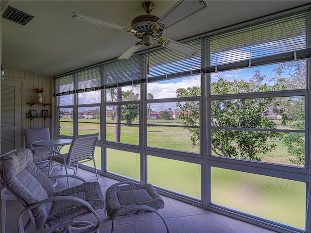 sunroom / solarium featuring ceiling fan