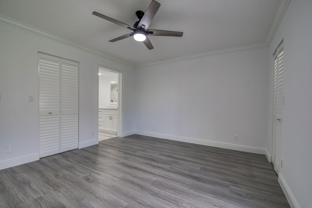 7281 Amberly Ln Unit 306, Delray Beach, FL 33446 - unfurnished bedroom featuring ornamental molding, dark wood-type flooring, baseboards, ensuite bathroom, and a ceiling fan