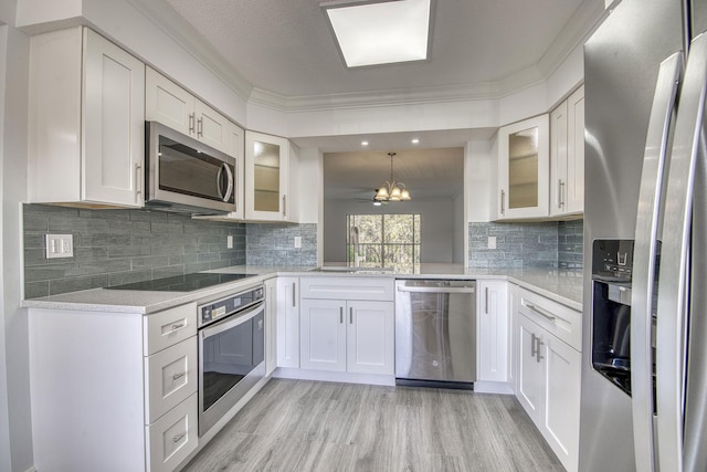7281 Amberly Ln Unit 306, Delray Beach, FL 33446 - kitchen with stainless steel appliances, light wood finished floors, a sink, light countertops, and glass insert cabinets