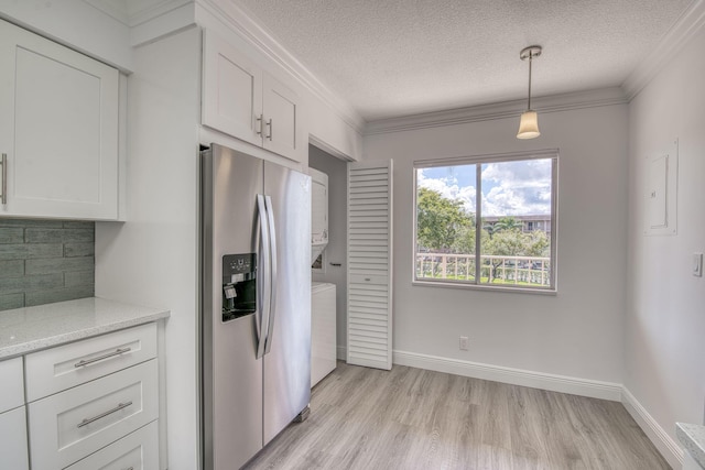 7281 Amberly Ln Unit 306, Delray Beach, FL 33446 - kitchen with stainless steel refrigerator with ice dispenser, light wood finished floors, separate washer and dryer, decorative backsplash, and white cabinets