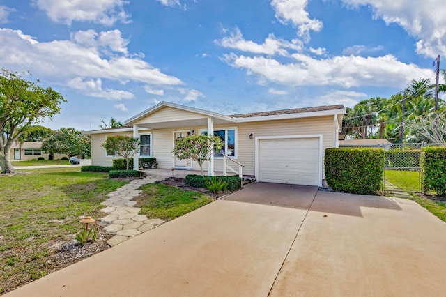 ranch-style home with concrete driveway, covered porch, fence, and an attached garage