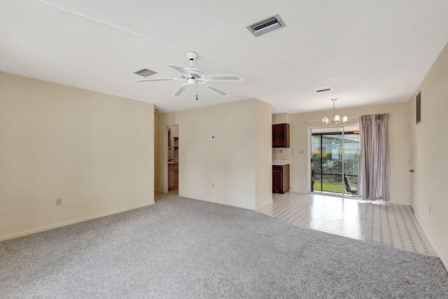 empty room featuring light colored carpet, visible vents, and ceiling fan with notable chandelier