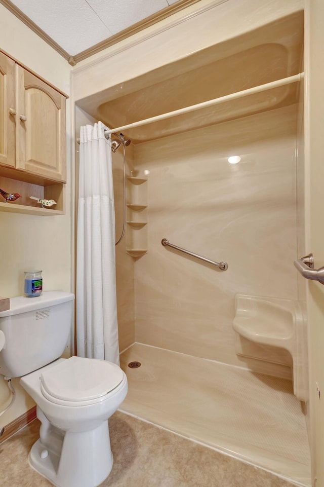 bathroom with toilet, a stall shower, tile patterned flooring, and ornamental molding