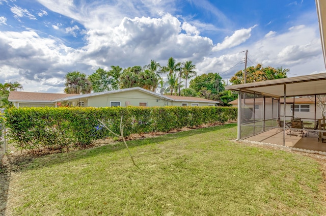 view of yard featuring a sunroom and a patio