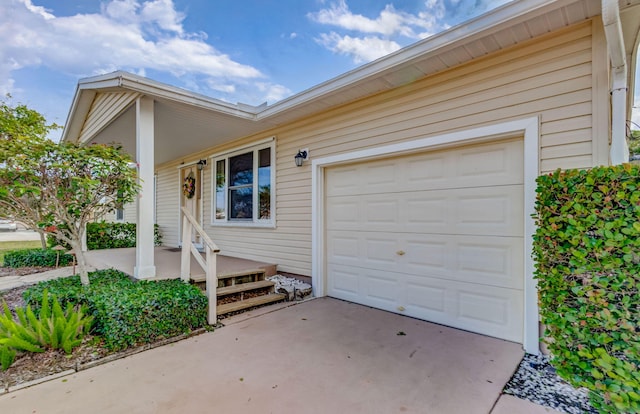 exterior space with driveway, covered porch, and a garage