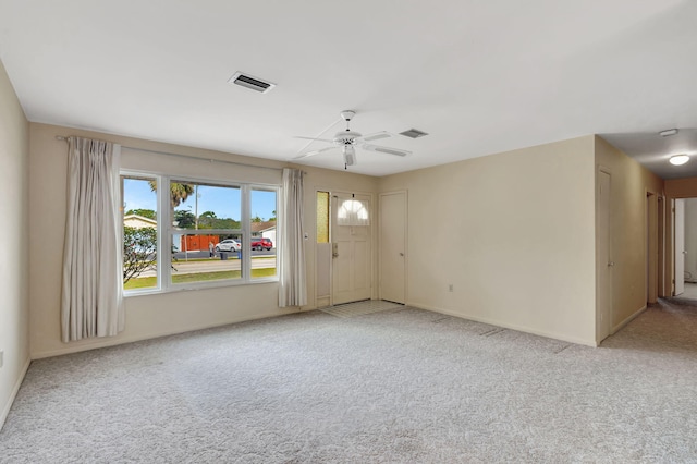 empty room featuring a ceiling fan, baseboards, visible vents, and carpet flooring