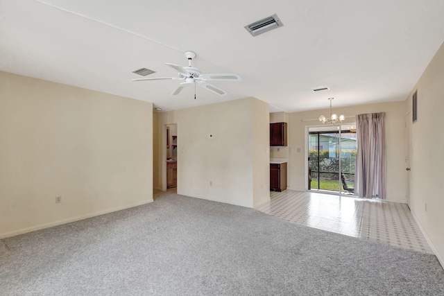 unfurnished room featuring ceiling fan with notable chandelier, visible vents, and light colored carpet