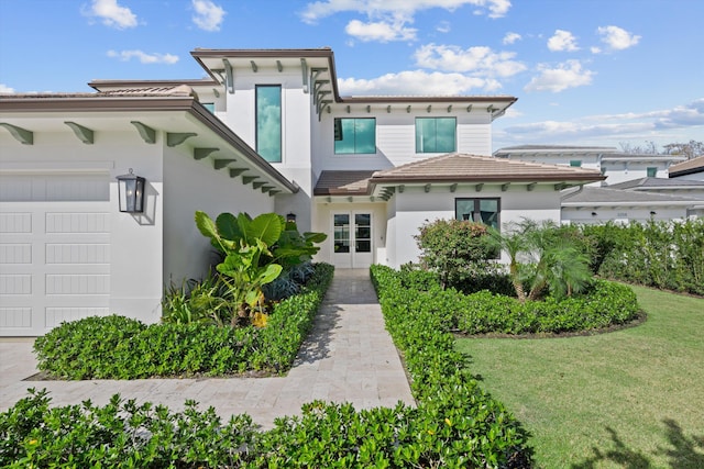 view of front of property featuring a garage and a front yard