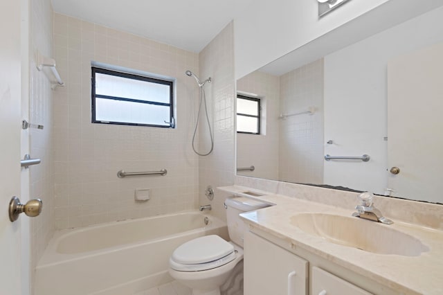 full bathroom featuring vanity, tiled shower / bath, and toilet