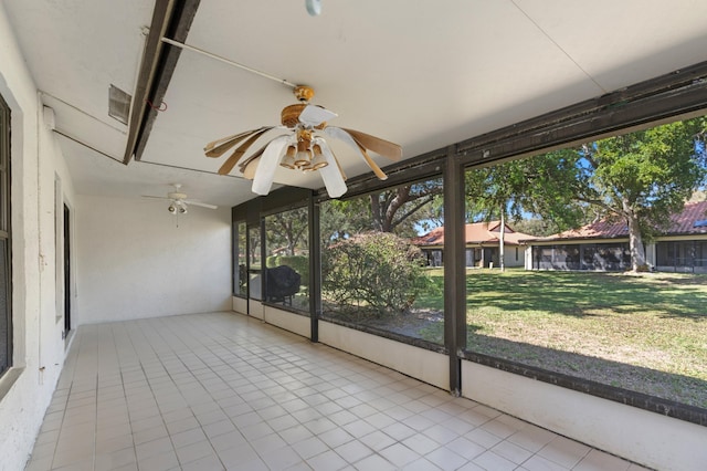 unfurnished sunroom with ceiling fan