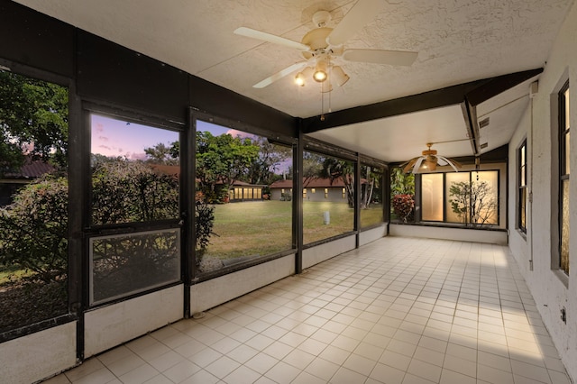 unfurnished sunroom with ceiling fan