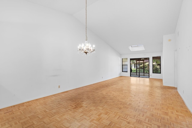 interior space featuring light parquet flooring, high vaulted ceiling, and a notable chandelier