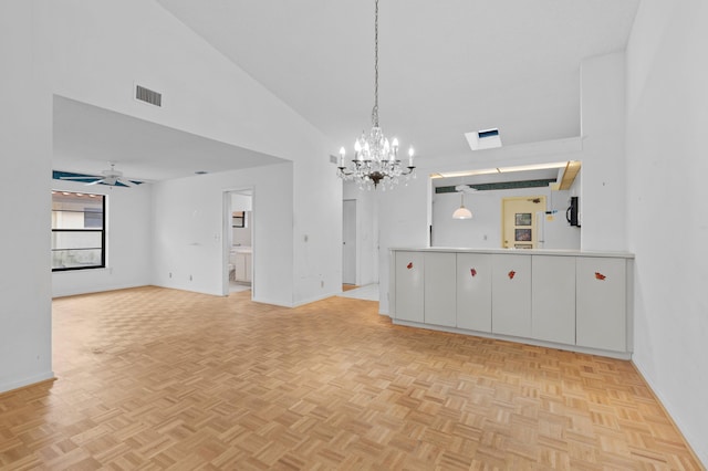 empty room featuring ceiling fan with notable chandelier, high vaulted ceiling, and light parquet floors