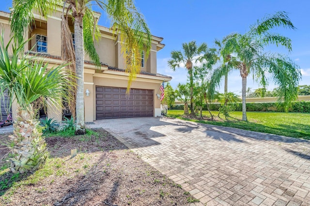 view of front of property featuring a garage and a front yard