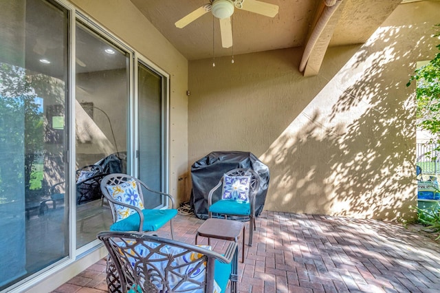 view of patio with a grill and ceiling fan