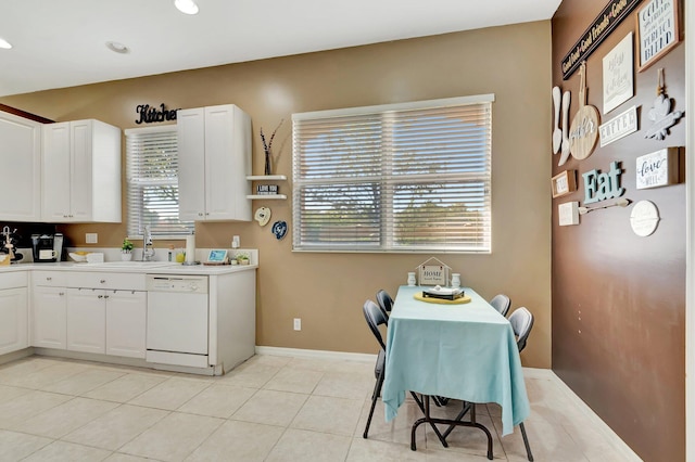 kitchen with white cabinetry, white dishwasher, sink, and light tile patterned floors