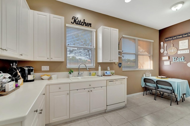 kitchen featuring sink, white cabinets, and dishwasher