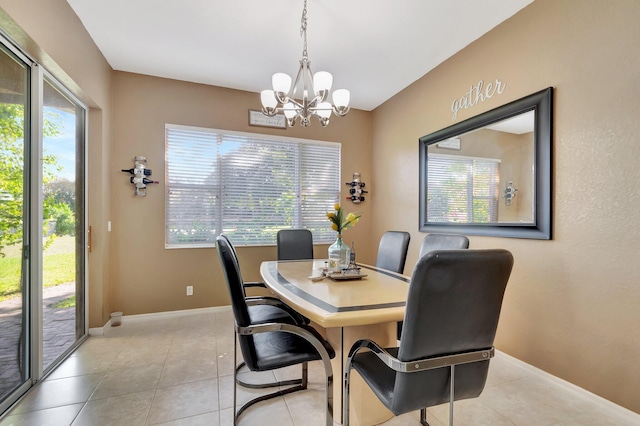 tiled dining area featuring an inviting chandelier