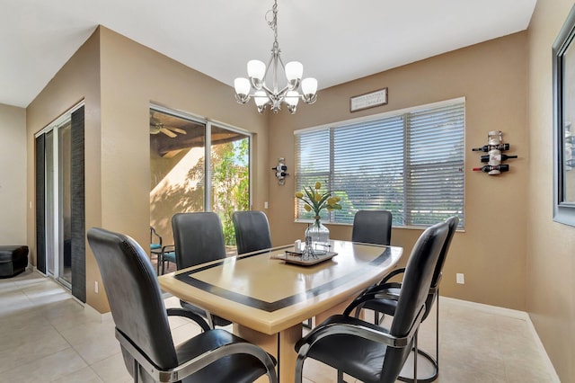 dining room with light tile patterned floors and a chandelier