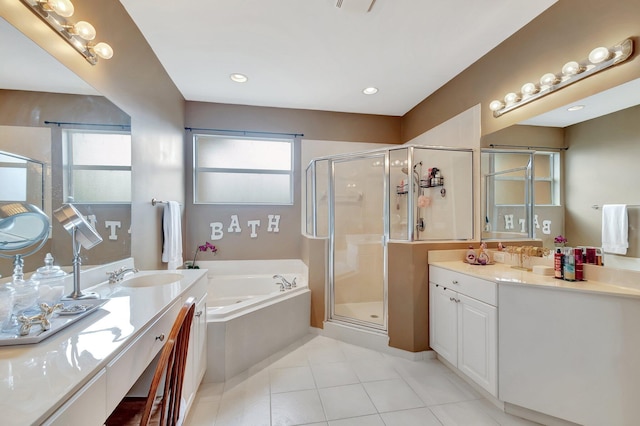 bathroom with independent shower and bath, vanity, and tile patterned flooring