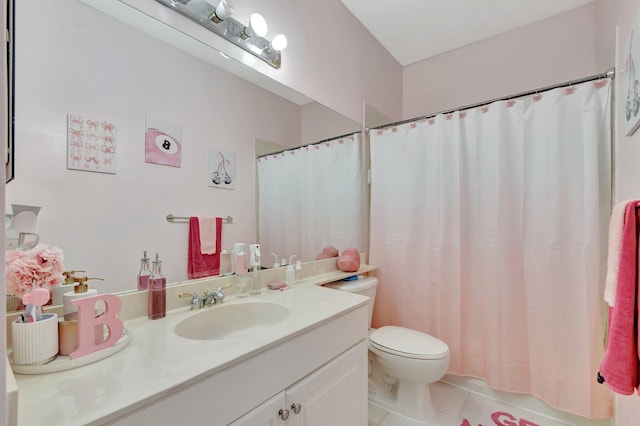 bathroom featuring tile patterned floors, vanity, and toilet