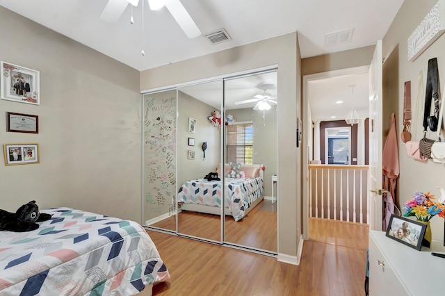 bedroom with wood-type flooring, a closet, and ceiling fan