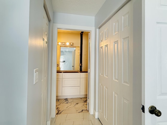 hallway featuring a textured ceiling