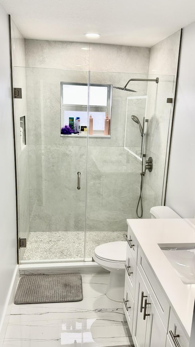 1001 Cape Cod Ter, Greenacres, FL 33413 - bathroom featuring marble finish floors, a stall shower, toilet, and vanity