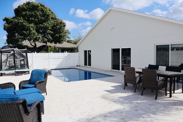 1001 Cape Cod Ter, Greenacres, FL 33413 - view of pool with a trampoline, a patio, a fenced backyard, and outdoor dining space