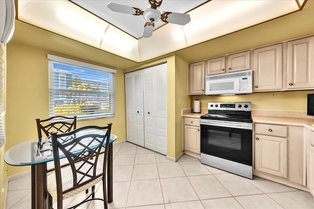 kitchen featuring electric stove, ceiling fan, and light tile patterned floors