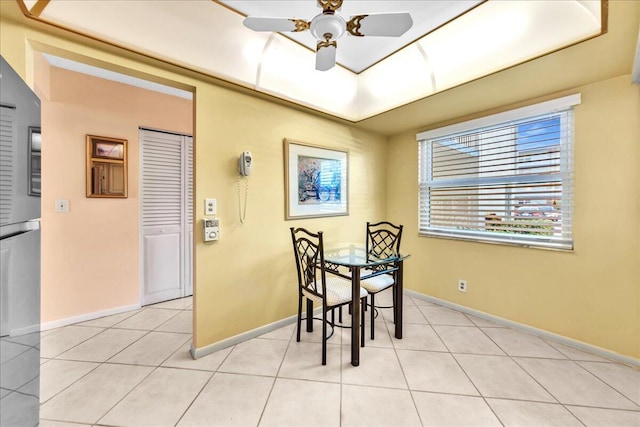 dining space with ceiling fan and light tile patterned floors