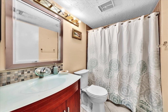 bathroom featuring tasteful backsplash, vanity, walk in shower, toilet, and a textured ceiling