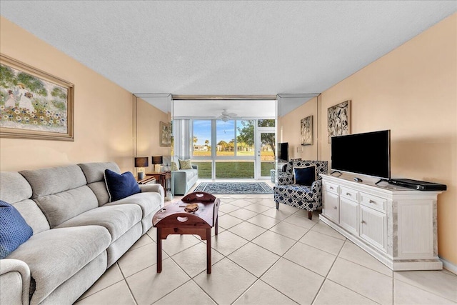 living room featuring light tile patterned flooring, floor to ceiling windows, and a textured ceiling