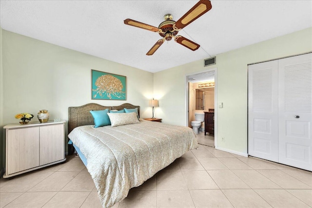 bedroom featuring light tile patterned floors, ensuite bath, a closet, and ceiling fan