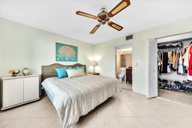 bedroom with ensuite bath, a closet, ceiling fan, and light tile patterned flooring