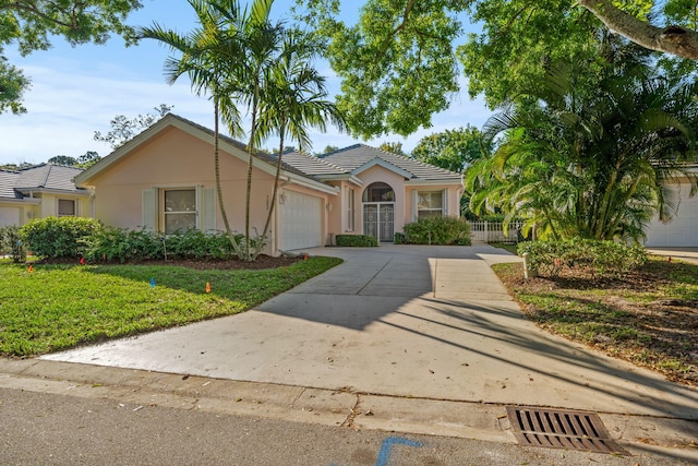 view of front of home with a garage and a front lawn