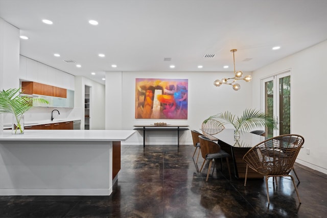 dining room with sink and an inviting chandelier