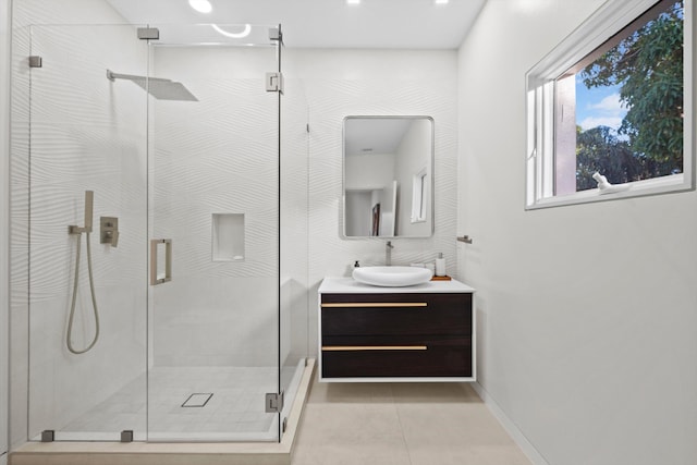 bathroom featuring vanity, tile patterned flooring, and a shower with door