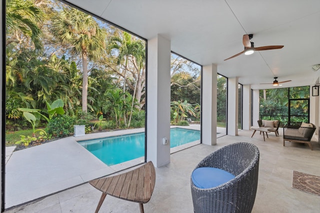 view of swimming pool featuring a patio and ceiling fan