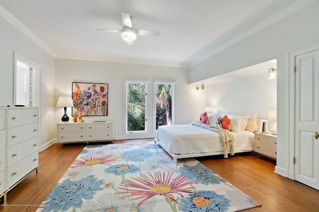 bedroom with ornamental molding, dark hardwood / wood-style floors, and ceiling fan